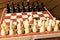 Black and white chess on a chessboard on a wooden table. Chess g