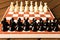 Black and white chess on a chessboard on a wooden table. Chess g