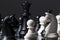 Black and white chess figures on chessboard. Checkmate game process