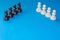 Black and white chess pieces on a blue background. Stop racism. Black lives matter