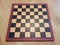 Black and white chessboard or checkerboard on wood floor