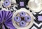 Black and white chevron with purple theme party table with cupcakes.