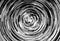 Black and white circular blur in the form of a whirl background texture, radial blur, abstract twist, funnel