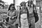 A black and white close up portrait of three poor women tea pluckers who just finished their work. they looks at the camera and