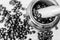 Black and white close up shot of mortar and pestle crushing coffee beans against wooden background