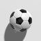 Black and white colored traditional soccer ball on white background