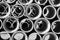 Black and white of concrete round pipes stacked.