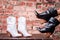 Black and White cossack boots leather with a brown heel dressed on a model, on a stone background. Village half. fashion shoes.