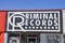 A black and white Criminal Records sign over a door with a neon open sign in Little Five Points in Atlanta Georgia