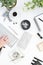 Black and white desk flatlay mockup with plants and woman typing