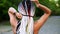 Black and white dreadlocks on the back of a girl. Rear view of a sporty girl combing hair with hair rubber for