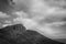 Black and white effect of unrecognizable tourists at the top of Old man of Storr