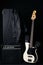 Black and white electric bass guitar with amplifier, jack cable