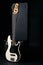 Black and white electric bass guitar, hard case