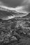 Black and white Epic Autumn landscape image of view along Nant Fracon valley in Snowdonia National Park with dramatic evening sky