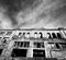 Black and white facade of old destroyed house. High contrast