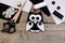 Black and white felt owl, felt sheets, scissors, threads, thimble, buttons on a vintage wooden table. Creating pretty owl ornament