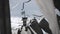 Black and white flags sway on wind in summer day. Cloudness sky before rain. Column with flag