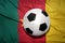 Black and white football ball on the national flag of cameroon