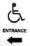 Black and white handicapped entrance sign with arrow.