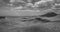 Black and White Image of Clouds Drifting over Desert