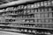 Black and White Image of Different types of cheese on shelves in a grocery store. Shelf of packaged products, butter and cheese at