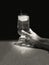Black and White image of a hand touching a glass of ice water