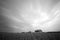 Black and white image of paddy field with abandon house and dramatic soft cloud effect