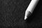 black and white image pencil for french manicure on a dark textured background horizontal