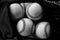 Black and white image of pile of baseballs.