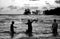 Black and white image of teenagers throwing fishing net