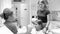 Black and white image of young mother and her teenage daughter visiting dentist