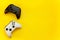 Black and white joystick on yellow background.