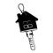 black and white key with house shaped keyring on white background