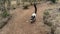 Black and white lemur vari Varecia variegata runs along a dirt track.