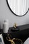 Black and white luxury feel dressing table corner in modern scandinavian style with gold circular lamp decorated / interior design