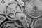 Black-and-white Metal Cogwheels in Oldest Clockwork, Macro.