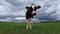 Black and white mottled dairy cow on the fresh green spring meadow