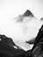 Black and white Mountains in cloud above a glacier