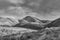 Black and white mountains with moody clouds