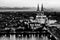 Black and white night landscape of the gothic Cologne cathedral, Hohenzollern Bridge and the River Rhine in Cologne, Germany