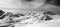 Black and white panorama of Caucasus Mountains in snow winter evening