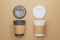 Black and white paper cup mockup with open lids for your design. Recyclable cardboard cups. Glasses on the background of craft