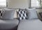 Black and white parallelogram pattern pillows on gray L shape sofa