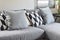 Black and white parallelogram pattern pillows on gray sofa