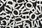 Black and white pattern of randomly placed letters of English alphabet. Close up