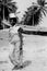 Black and white photo of African women carrying pots on their heads in Accra, Ghana