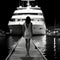 Black and white photo of amazing yacht boat dock landscape view with beautiful back view of model lady. generative ai