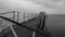 Black and white photo - broken bridge in the sea