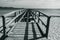 Black and white photo, disassembled wooden pier on the European sea